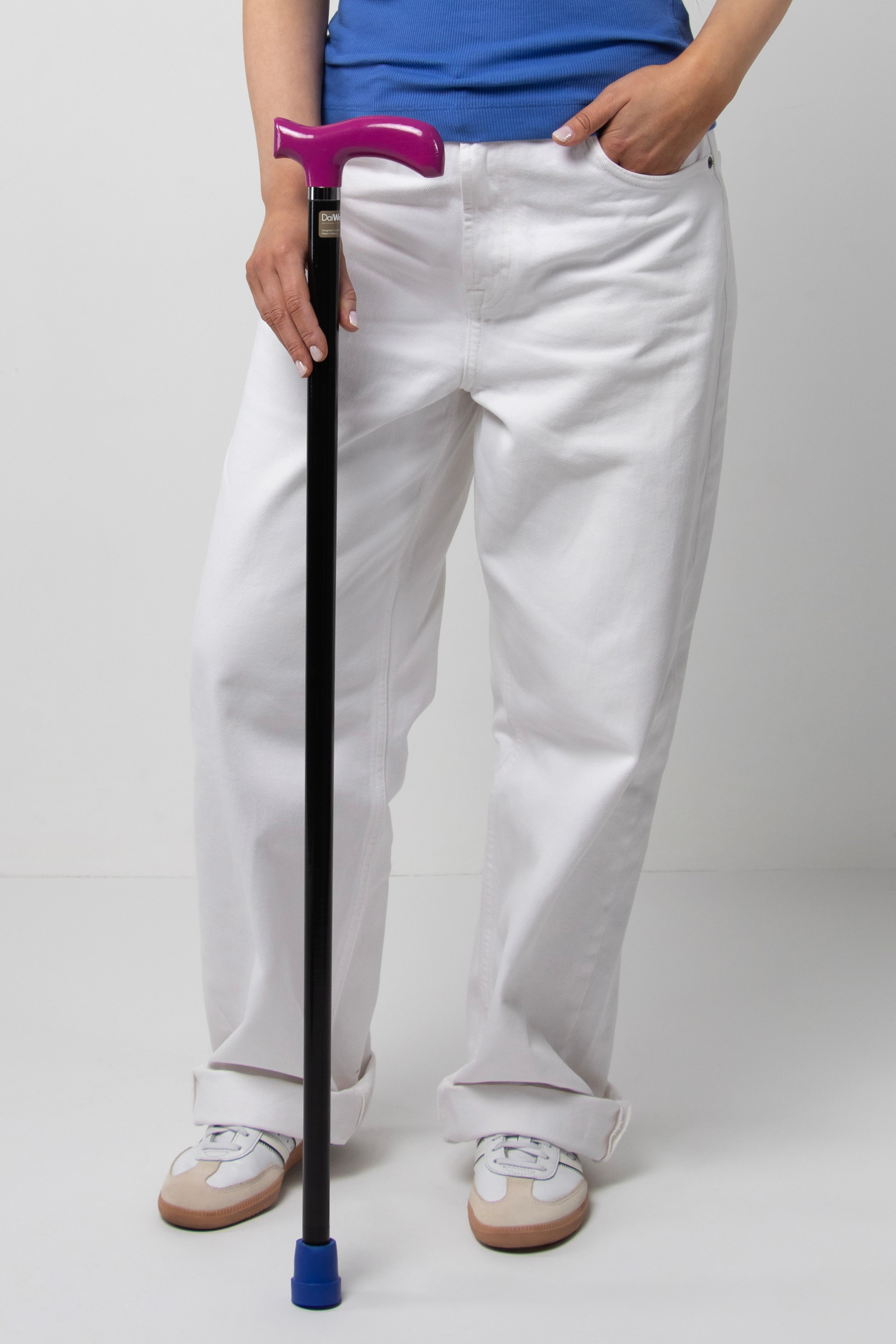 Chic women's designer walking cane with fuchsia handle and minimalist black shaft. Perfect for active women's urban outfits.