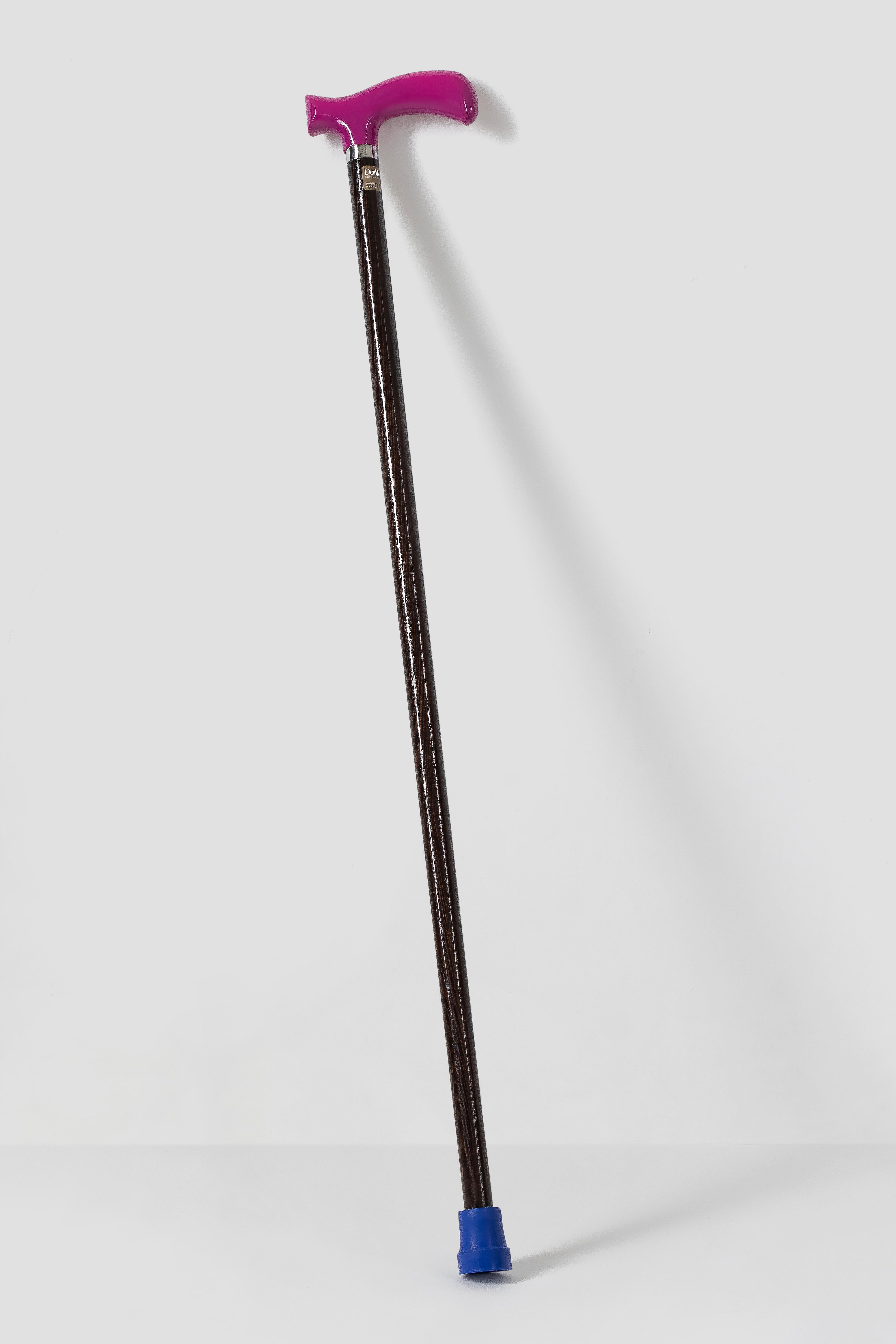 Fuchsia pink ergonomic walking stick on dark walnut oak wood. Stylish custom length cane for modern posture.