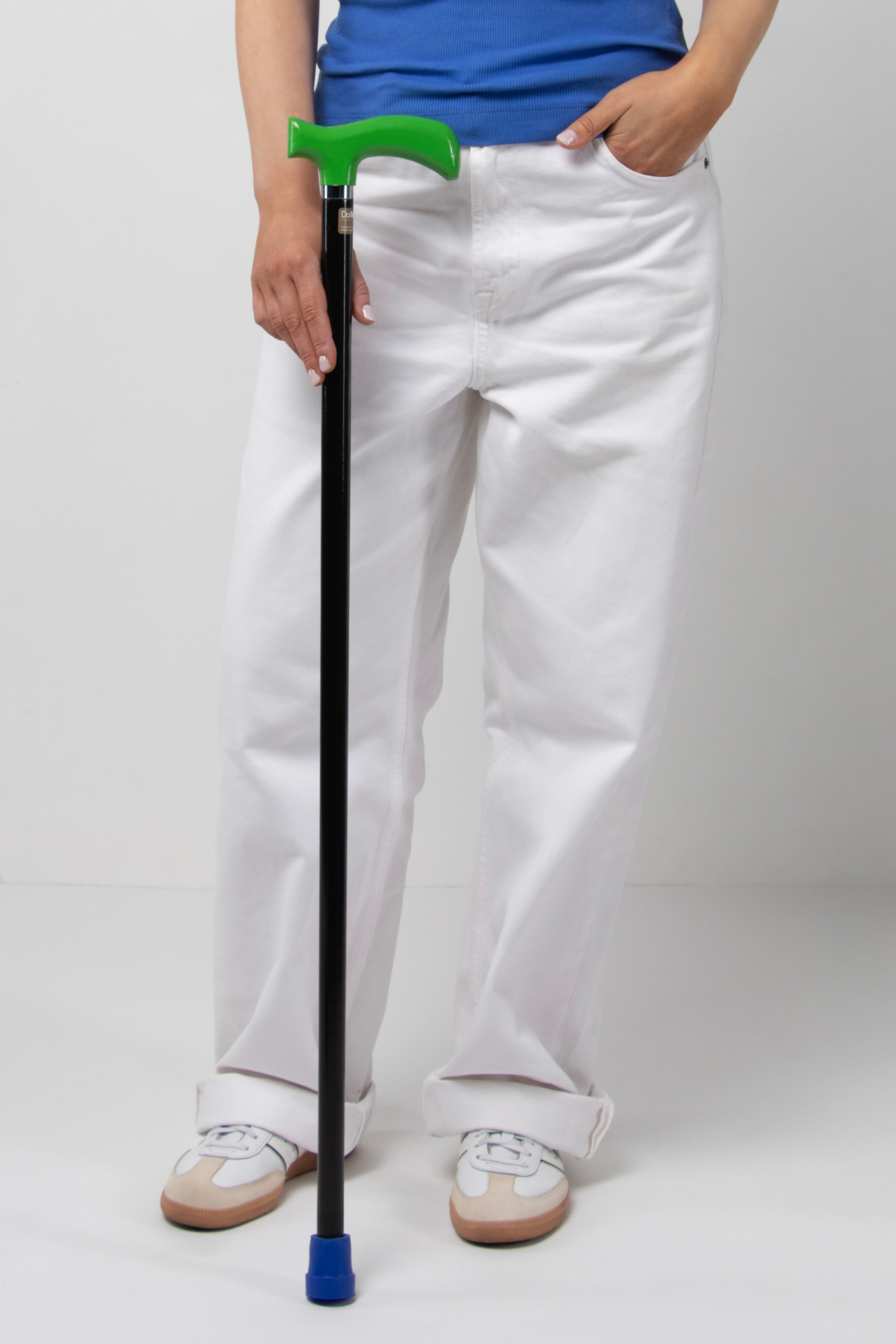 High-performance women's designer walking cane with green handle and black shaft. A lightweight statement piece for contemporary women.