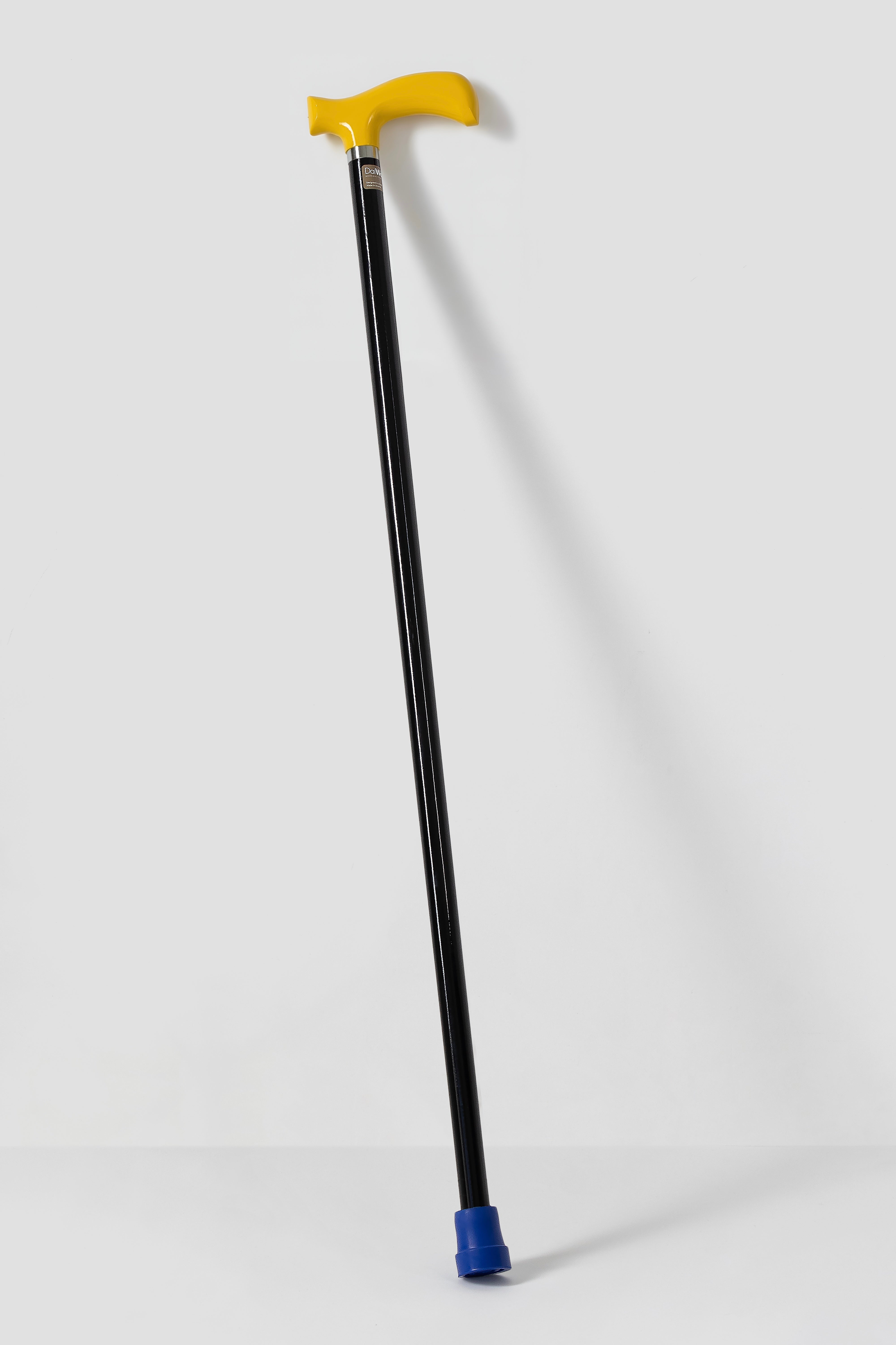 Modern yellow handle on solid black shaft. Urban style designer walking cane with non-slip rubber tip.
