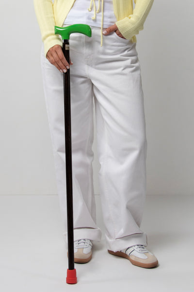 Stylish women's walking stick with green ergonomic handle on dark walnut oak. Premium custom cane for women with a new era of mobility.