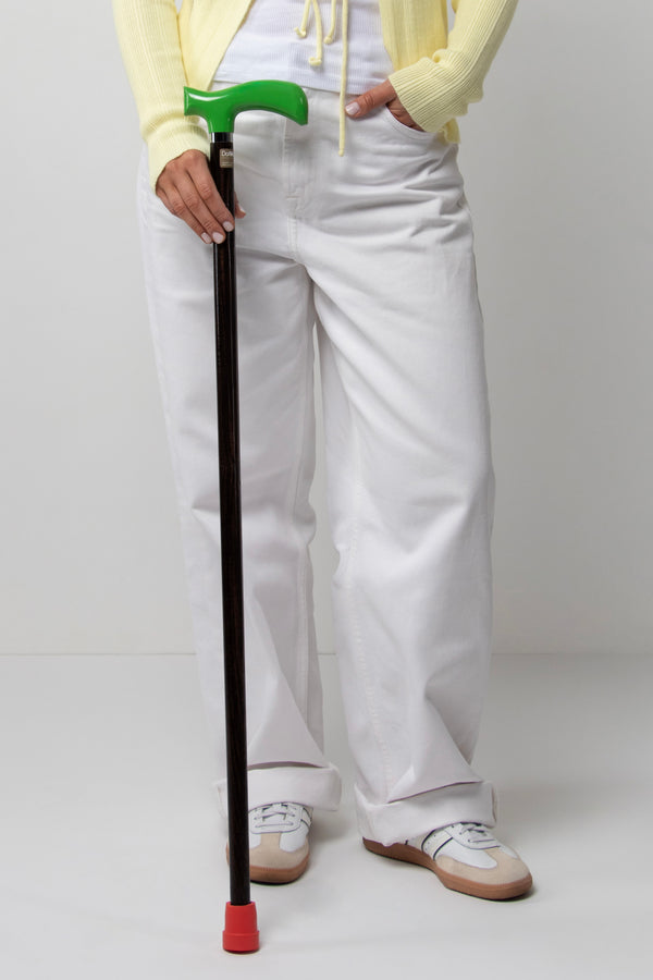 Stylish women's walking stick with green ergonomic handle on dark walnut oak. Premium custom cane for women with a new era of mobility.