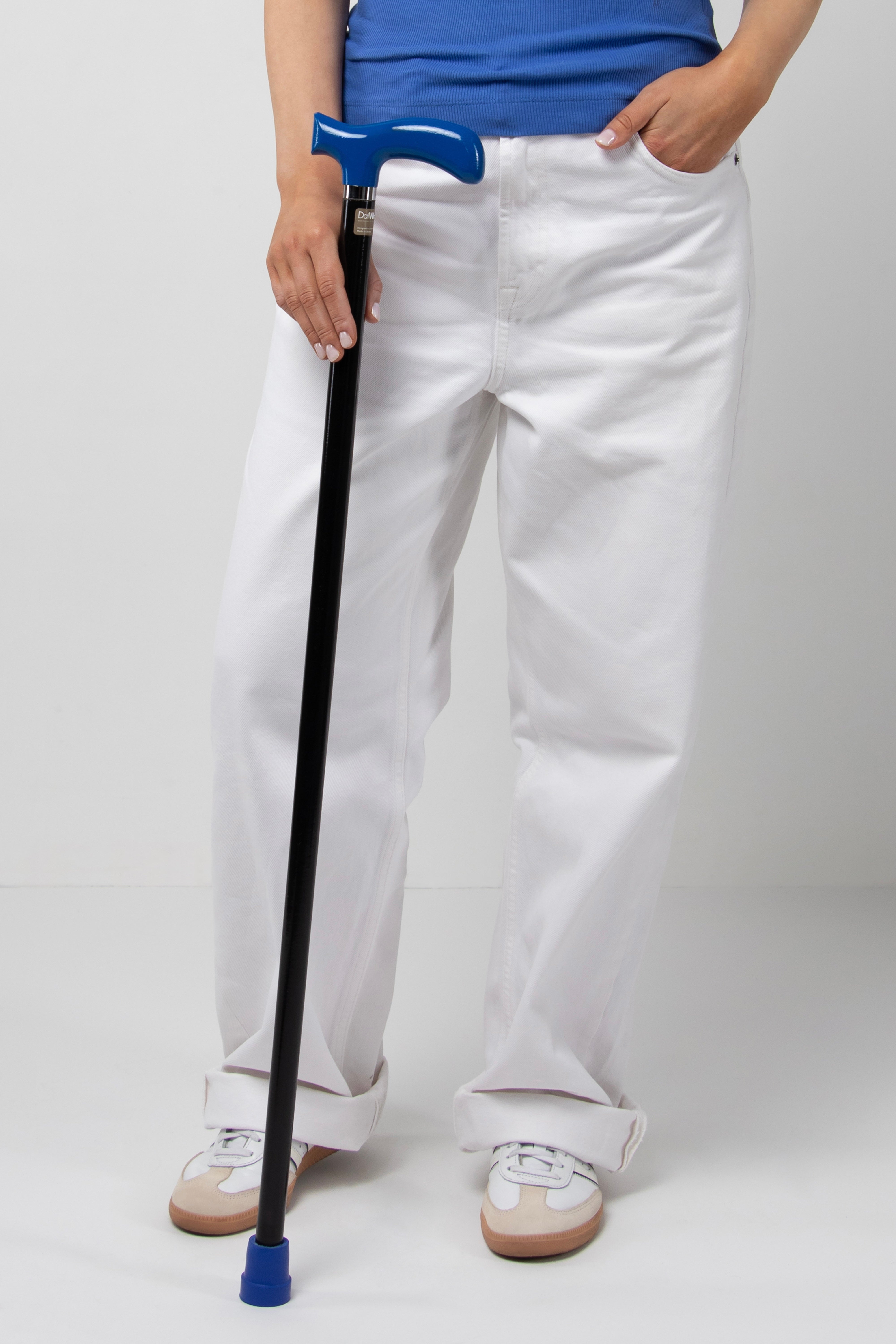 Tactical chic women's walking cane with deep blue handle and matte black shaft. Lightweight ergonomic aid for modern women's active lifestyle.