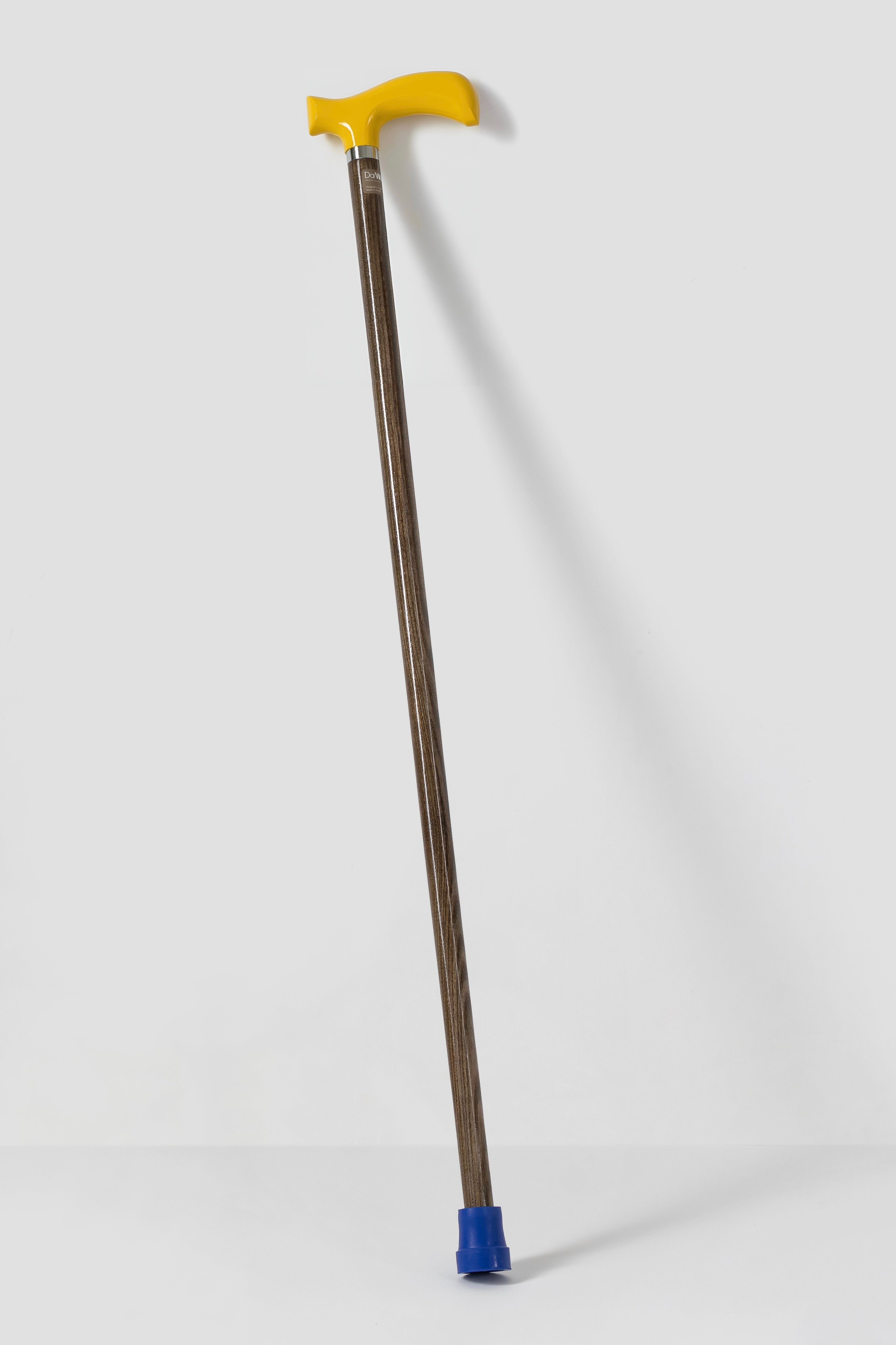 Traffic yellow stylish walking cane with light natural oak. High-visibility designer mobility aid for active adults.