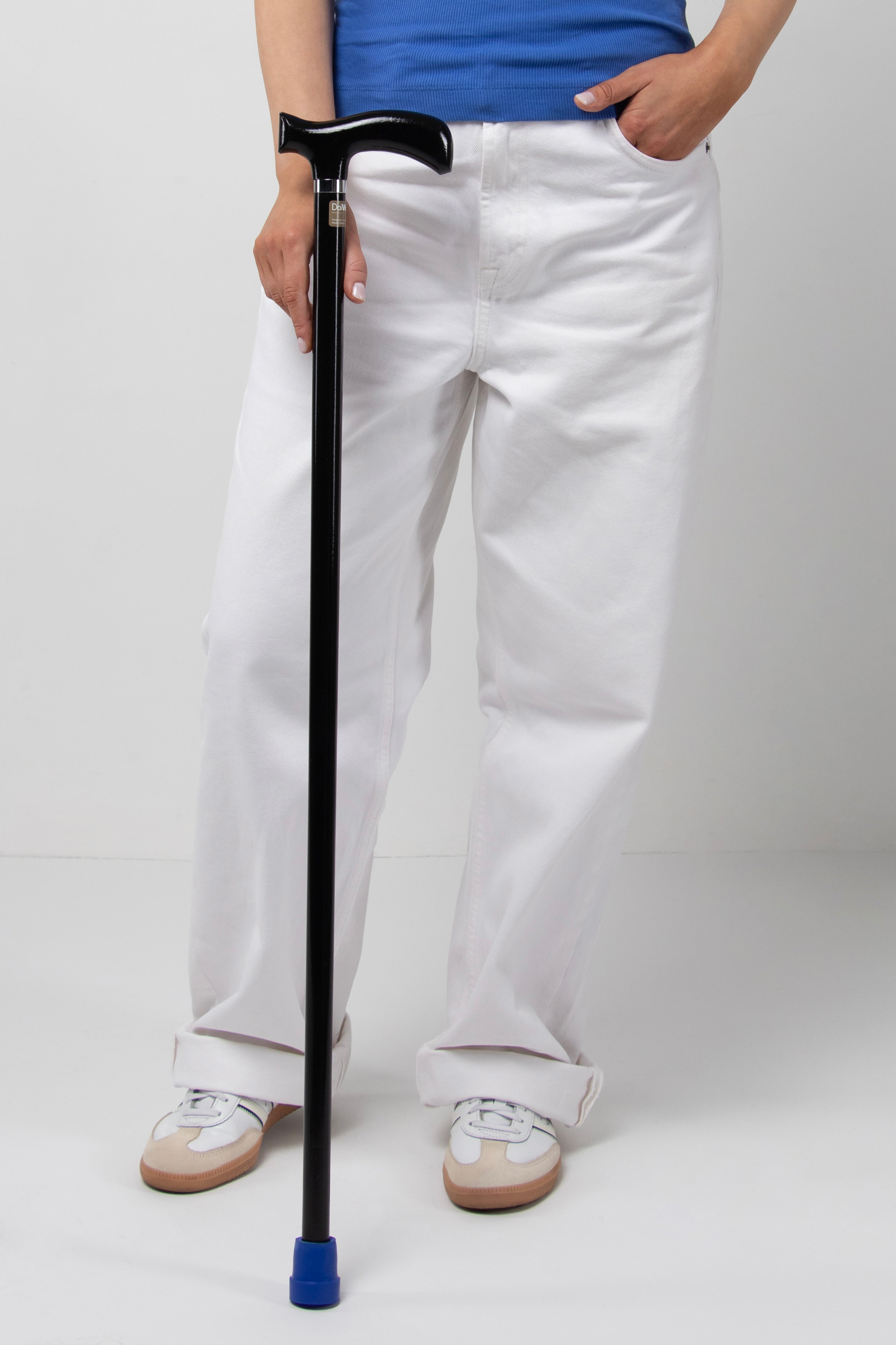 Triple Black women's minimalist walking cane. All-black custom made ergonomic aid for modern women's active and silent stride.