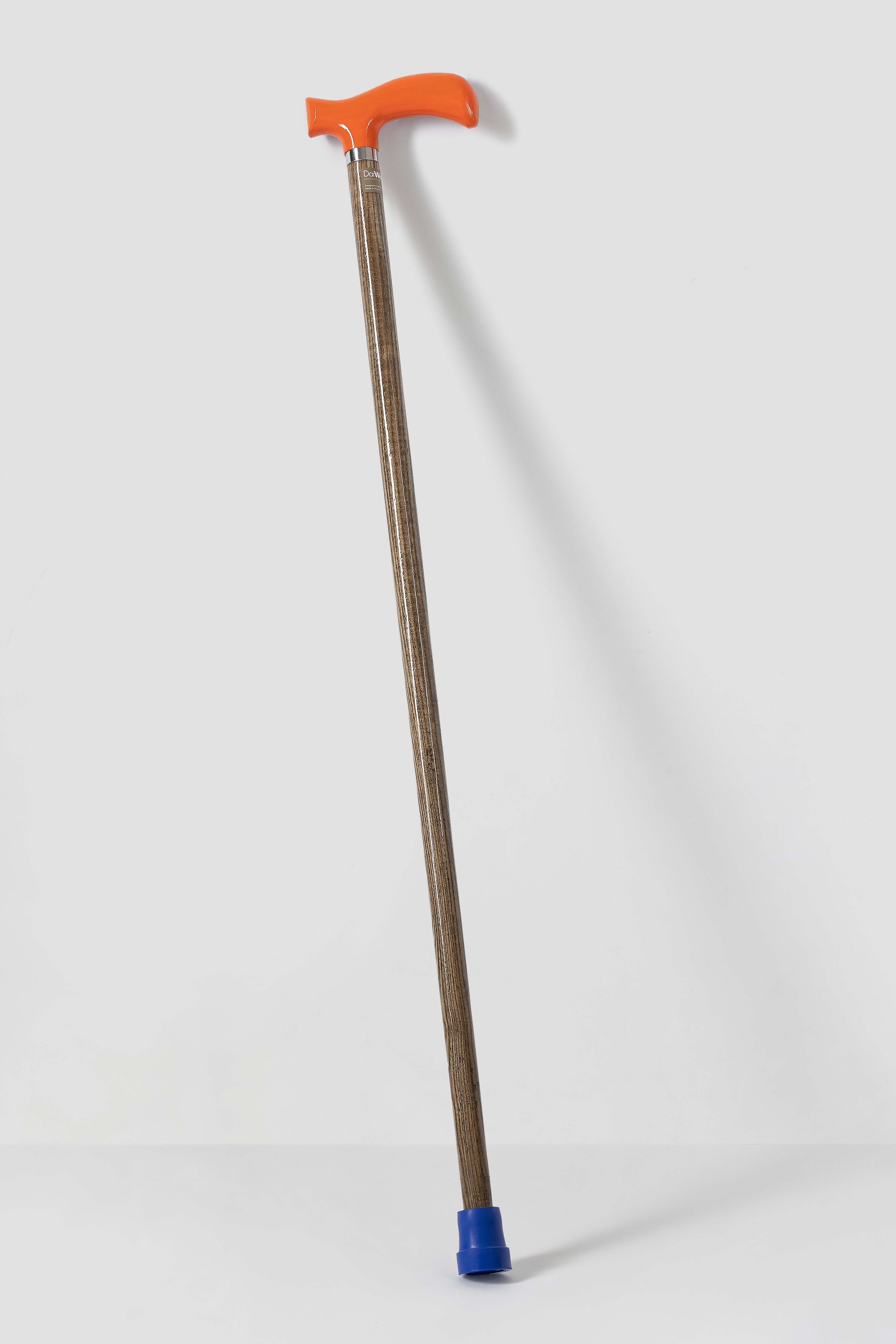 Full length DaiWalk Original 1.0 walking cane with vibrant orange anatomical handle, natural oak wood shaft, and blue rubber tip. Custom-sized premium mobility aid.