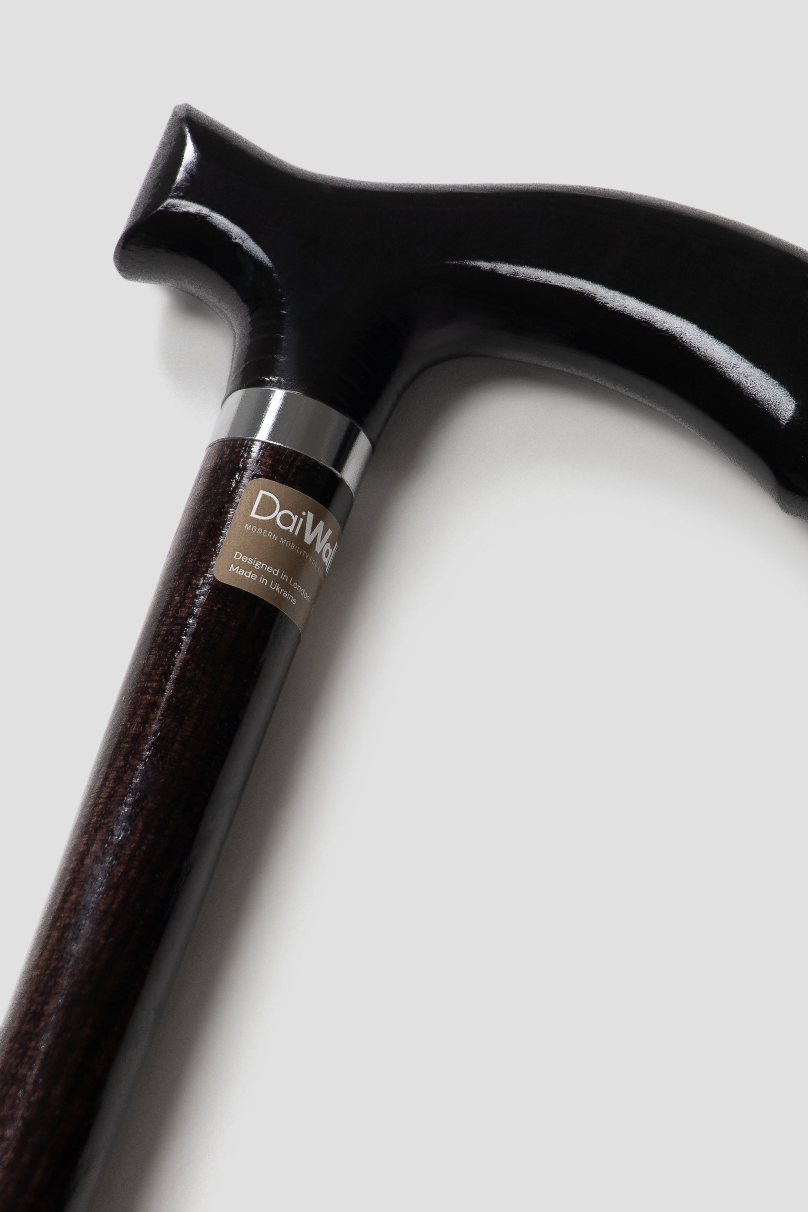 Professional men’s black anatomical walking stick with dark oak wood. Stealth luxury cane for stable and silent stride.