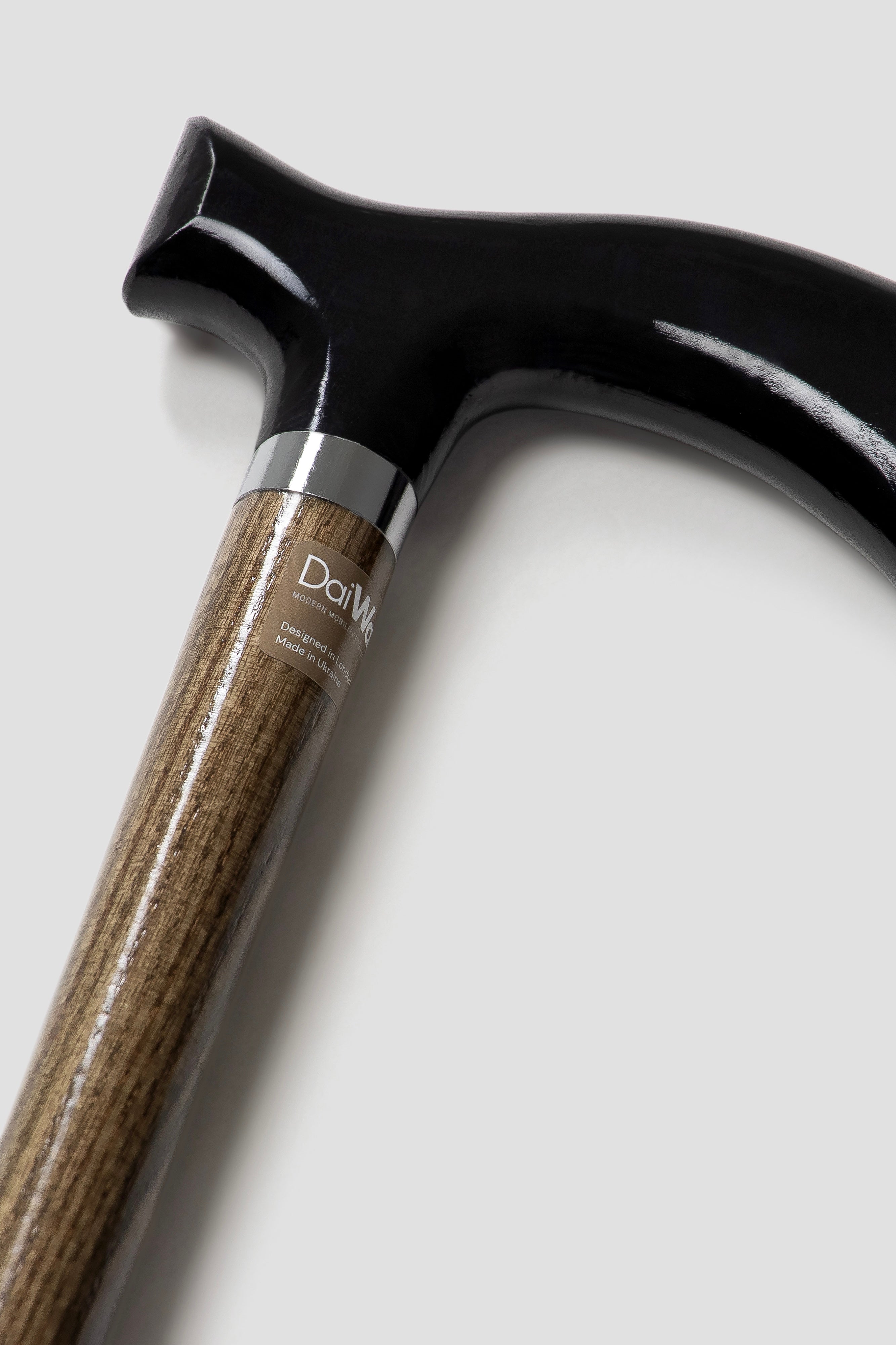 Minimalist men’s black handle walking cane with light oak shaft. Stylish custom length aid for perfect posture.