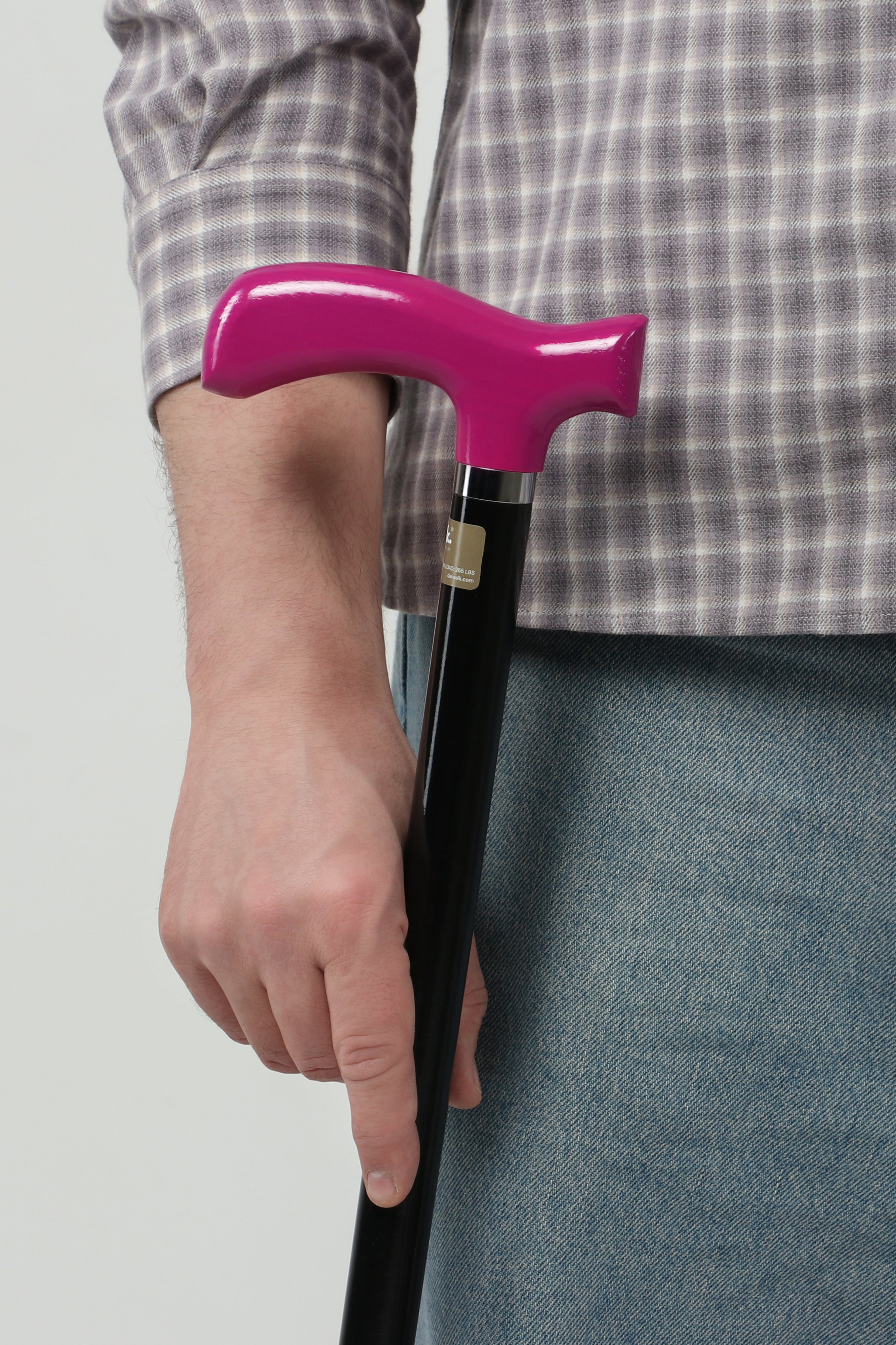 Modern men's designer walking cane with fuchsia handle and sleek black minimalist shaft. High-performance lightweight mobility aid for urban lifestyle.