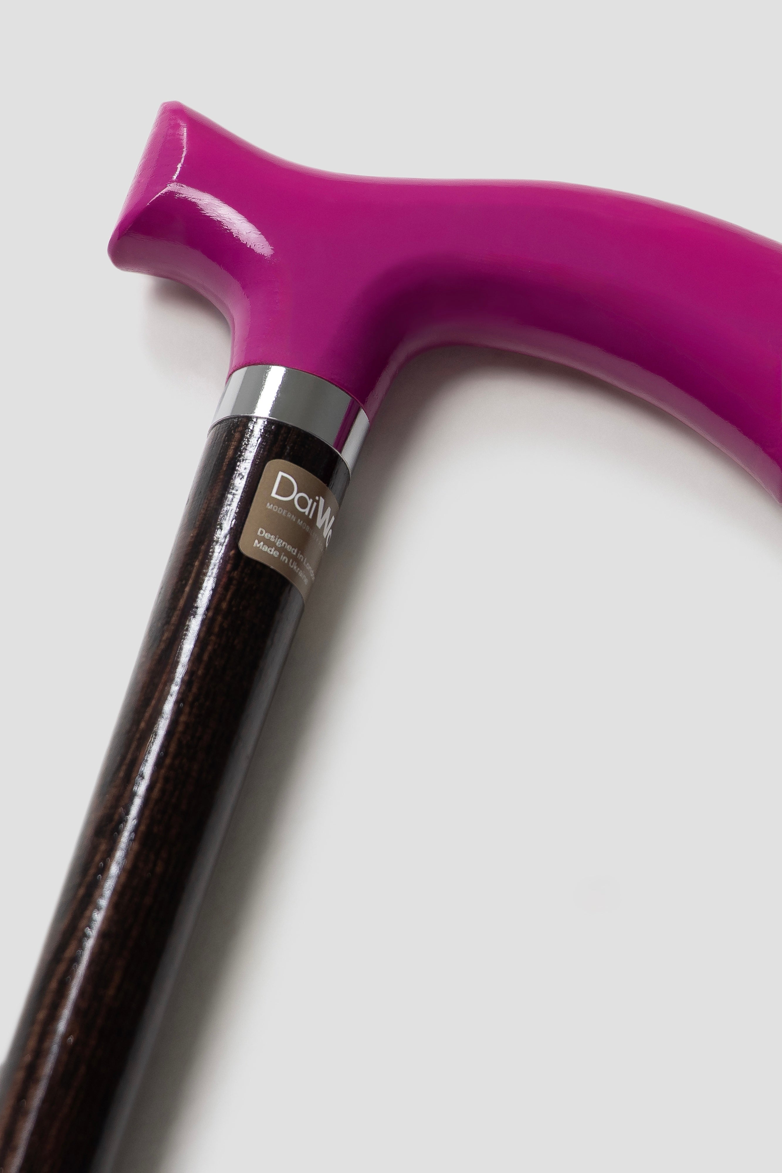 Sophisticated men's walking stick with fuchsia pink handle and dark walnut oak shaft. Bespoke designer cane for professional support and style.