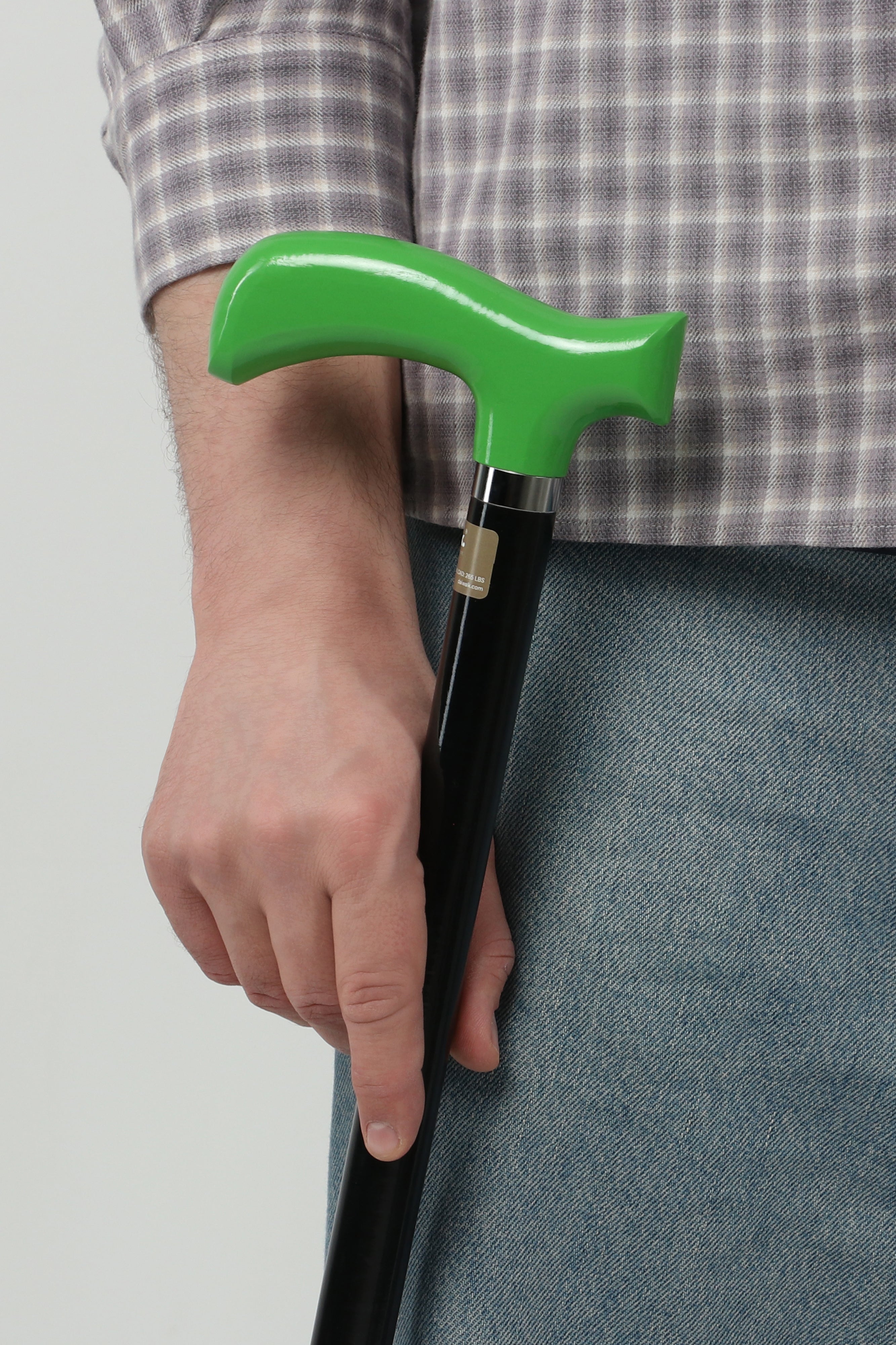 Tactical chic men’s walking cane with traffic green handle and matte black shaft. Modern lightweight mobility aid for urban lifestyle.