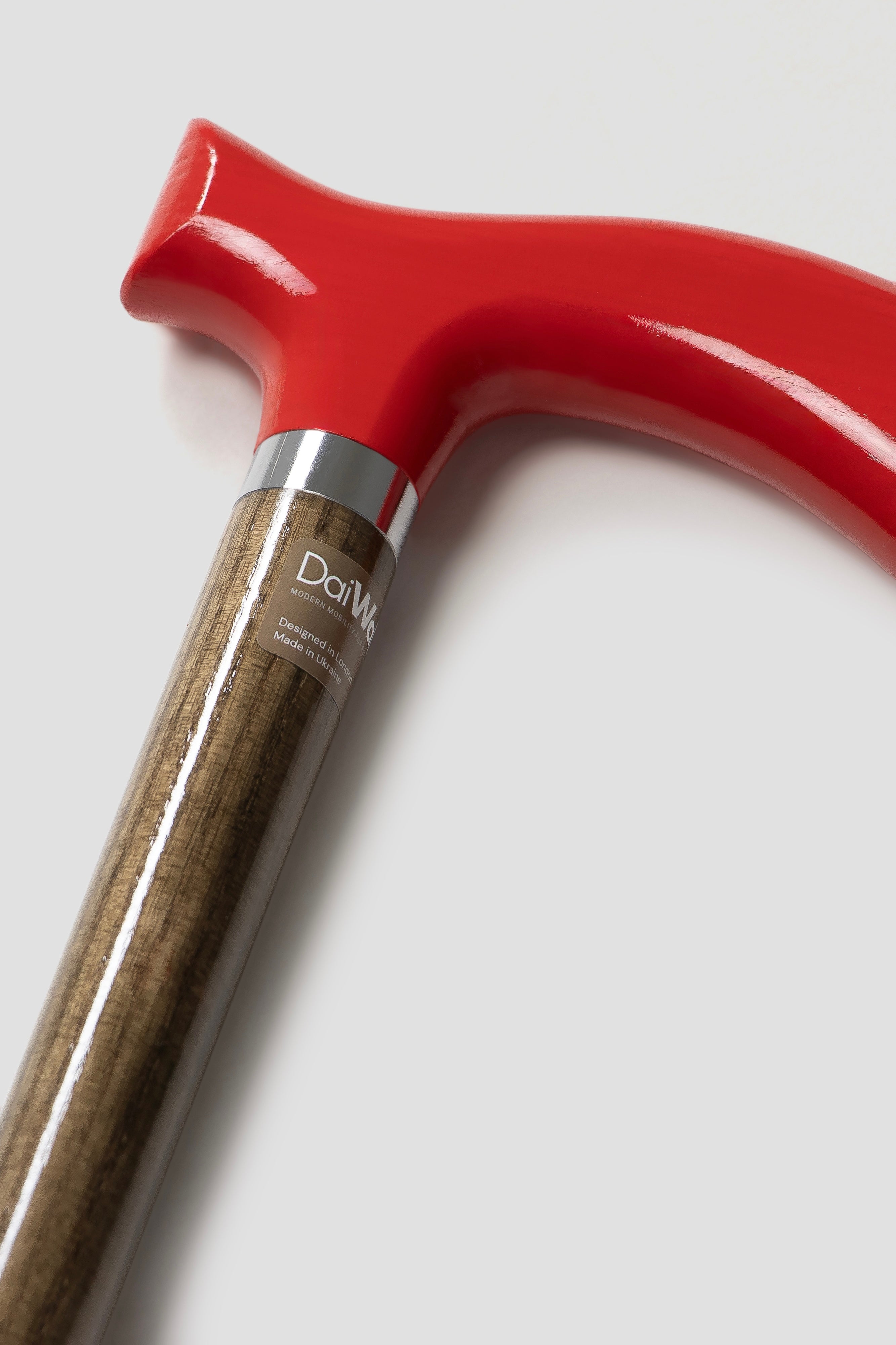 Classic dark red handle walking cane for men with light oak wood. Timeless designer mobility aid for daily support.