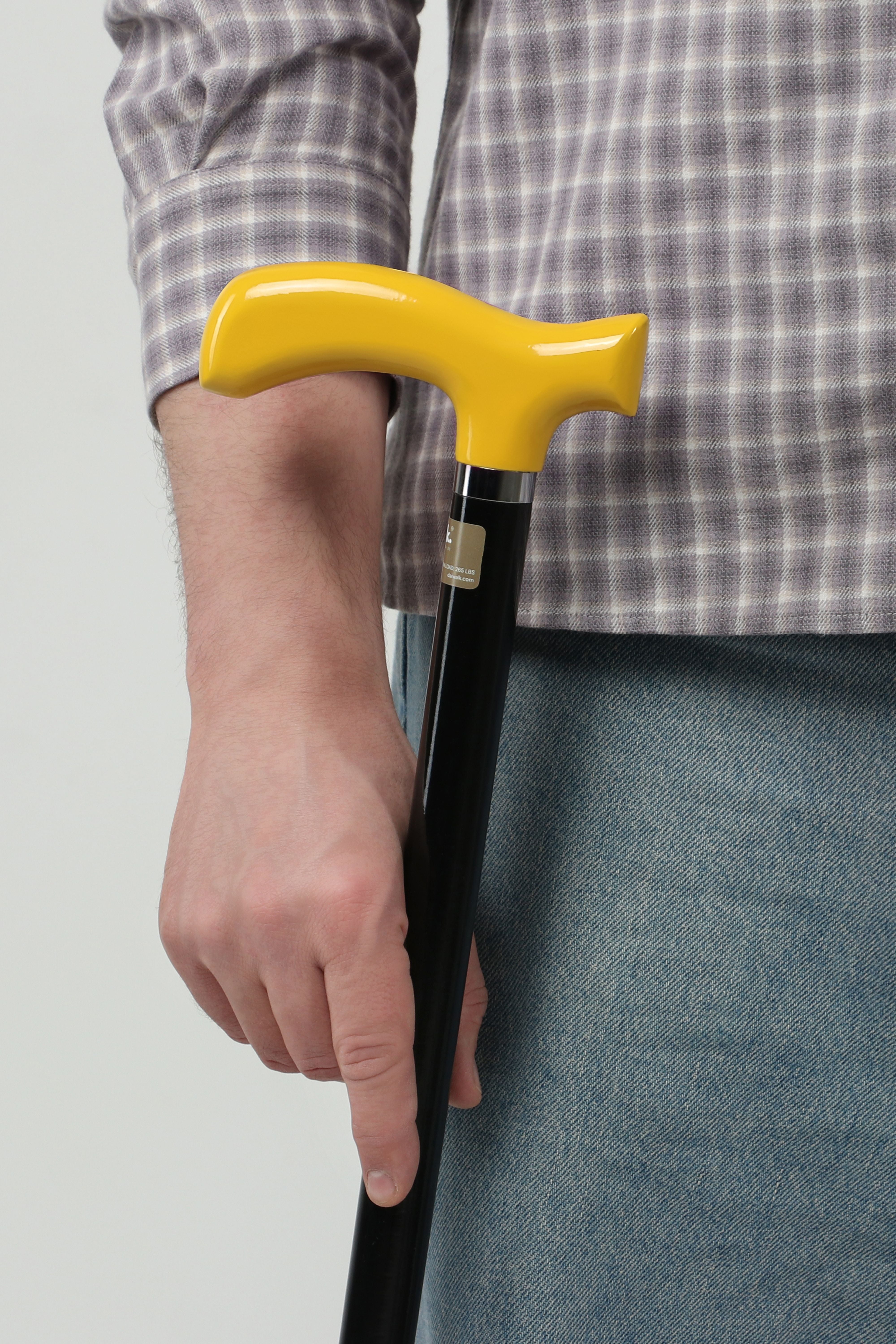 Urban yellow handle walking cane with black shaft for men. Modern ergonomic mobility tool with street-style aesthetics.