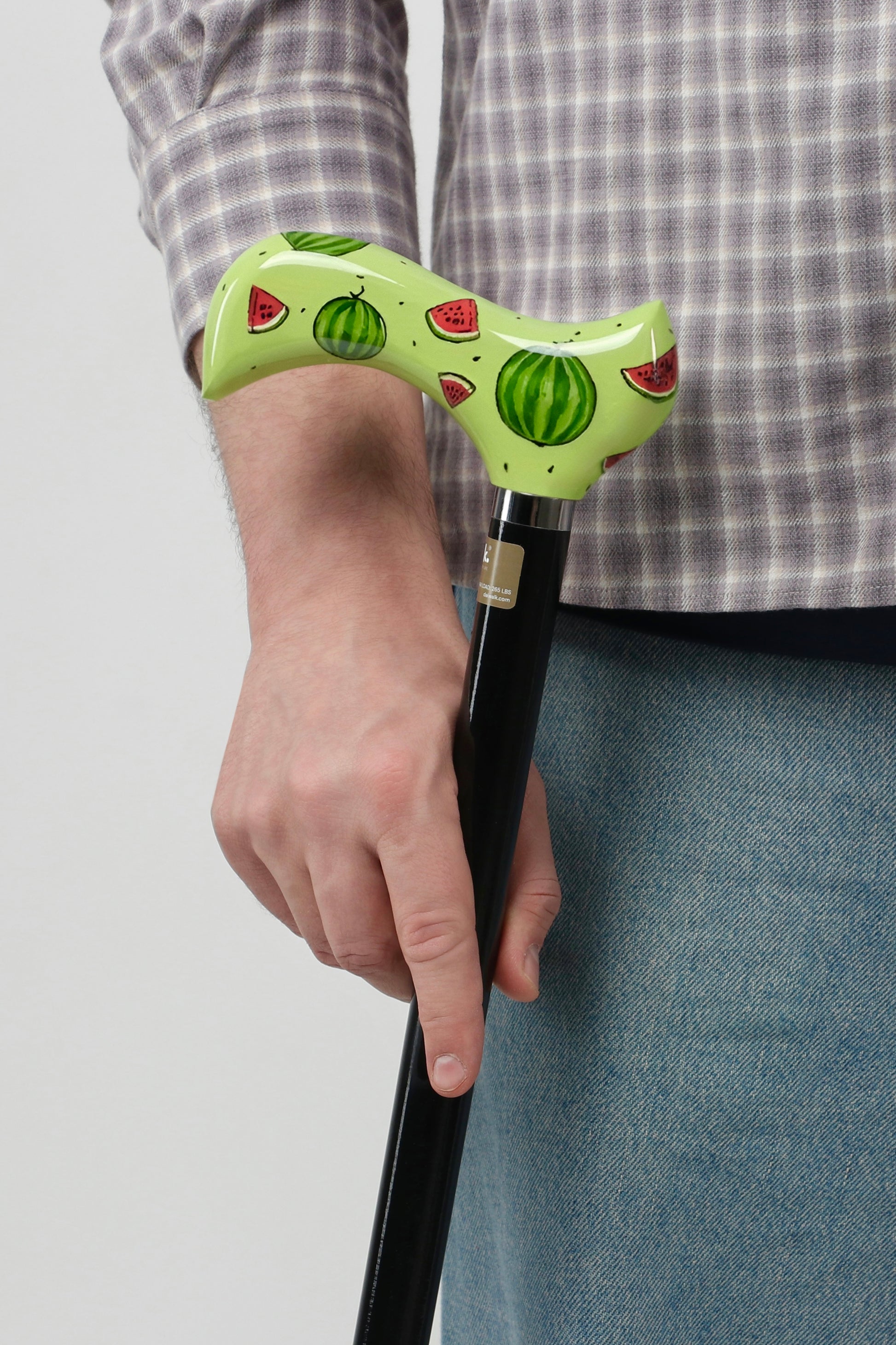 Urban streetwear walking stick with bold graphic pattern handle. Designer mobility accessory for men's techwear and street fashion outfits.
