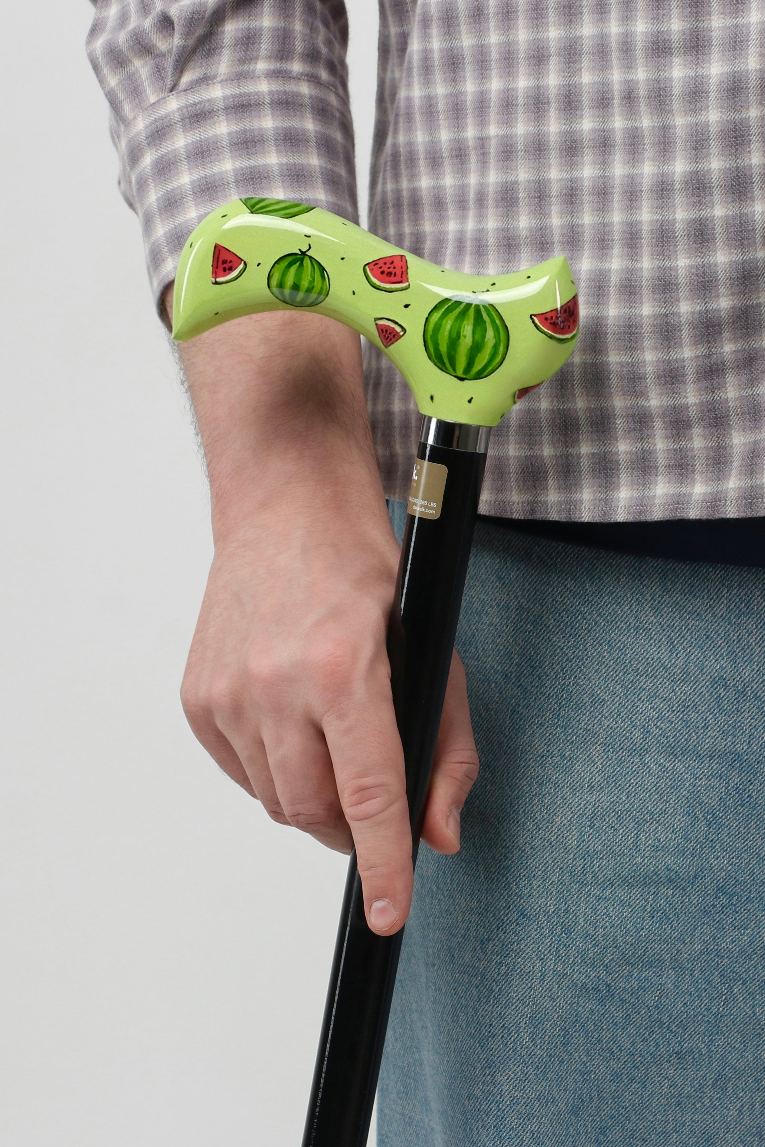 Urban streetwear walking stick with bold graphic pattern handle. Designer mobility accessory for men's techwear and street fashion outfits.